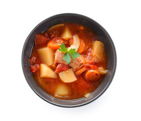Black bowl with delicious beef stew and parsley on white background