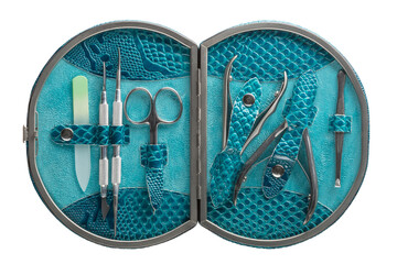 Set of steel manicure instruments and tools in blue leather case isolated on white background