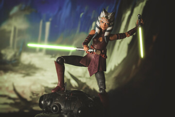 Naklejka premium NEW YORK, USA - DECEMBER 5 2023: Star Wars the Clone Wars Jedi padawan Ahsoka Tano battling a droid with lightsabers - Hasbro action figure