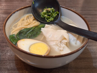 noodle and dumpling soup in bowl