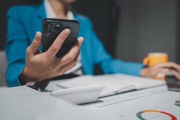 Beautiful woman in the office, happy, businesswoman uses internet phone close up, businesswoman checks email on smartphone, manager uses mobile phone, women in suit writes  message on smartphone