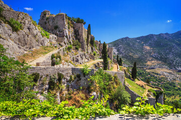 Summer landscape - view of the ruins of the Klis Fortress, near Split on the Adriatic coast of Croatia - obrazy, fototapety, plakaty