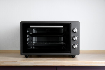 Obraz premium One electric oven on wooden table indoors