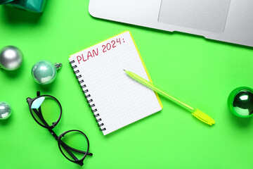 Notebook with text PLAN 2024, pen and eyeglasses on green background
