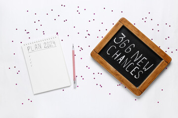 Notebook with empty to do list and chalk board with text 365 NEW CHANCES on white background