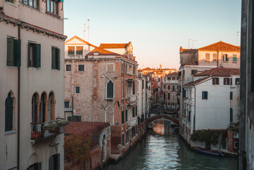 Fototapeta na wymiar A serene canal in Venice, Italy, captured from an unknown angle. The water flows peacefully, with no boats in sight. The surrounding buildings and time of day are unspecified.