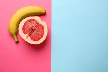 Banana and half of grapefruit on color background, flat lay with space for text. Sex concept
