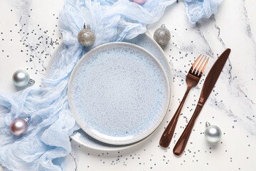 Beautiful table setting for Christmas dinner with decorations on white grunge background