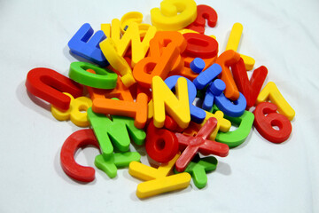 Colourful alphabet character written in multicolored plastic for kids. kids learn letters.