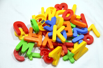 Fototapeta premium Colourful alphabet character written in multicolored plastic for kids. kids learn letters.