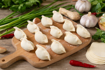 making dumplings in the kitchen. traditional food raw dimplings	