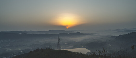 Fototapeta na wymiar Sunrise in the Winter Mountains amid the Morning Mist