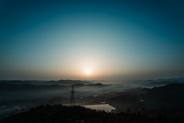 Sunrise in the Winter Mountains amid the Morning Mist