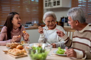 Asian lovely family having dinner, enjoying evening party in house.