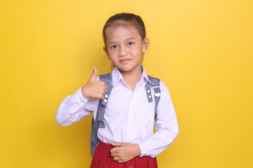 Asian schoolgirl in uniform wear rucksack showing thumb up with happy expression 