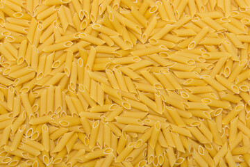 Penne pasta background. Pasta texture, pasta top view. Kitchen and product concept. 