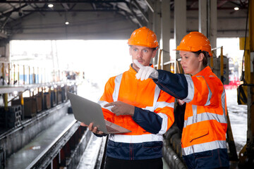 Young caucasian engineer man and woman checking train with laptop in station, team engineer inspect system transport, technician examining infrastructure, transportation and industry. - obrazy, fototapety, plakaty