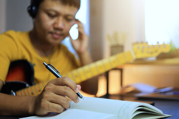 Musician writing song or compose melody by using the electric guitar as a musical instrument