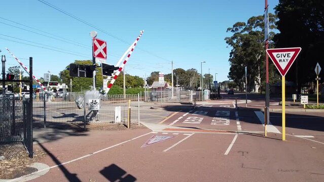 Barrier closing to stop vehicles, train is due. Railway industry safety