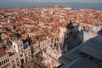 Fototapeta na wymiar Aerial view of Venice cityscape, evoking serenity and tranquility. The image showcases the unique layout, iconic canals, and historic architecture, capturing the essence of Venice during the summer.