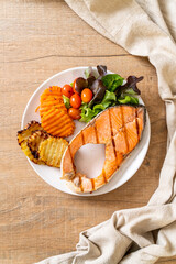 grilled salmon steak fillet with vegetable and french fries