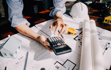 architect man working with laptop and blueprints,engineer inspection in workplace for architectural...