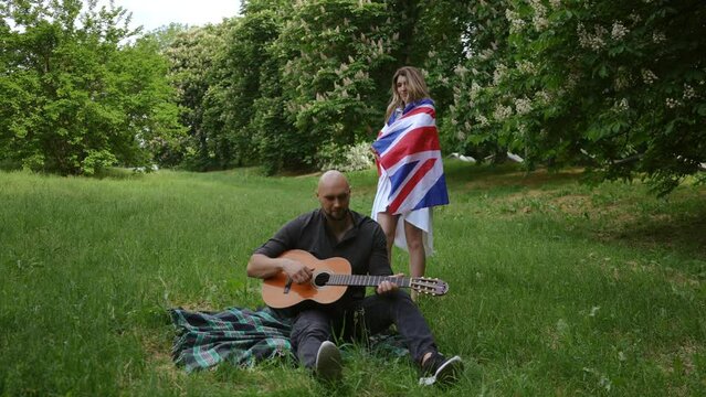 Happy couple celebrating in city park Summer bank holiday