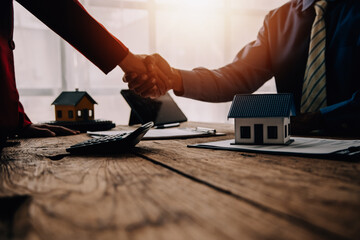Real estate broker agent presenting and consult to customer to decision making sign insurance form agreement, buy and sell home model, concerning mortgage loan offer for and house insurance