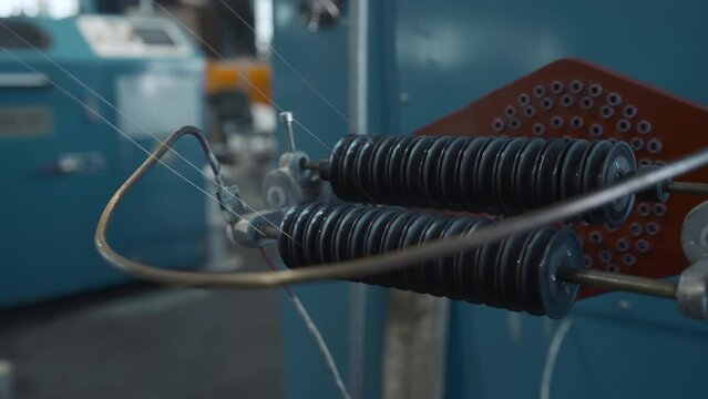 Coil winder machine with copper wire. Creative. Copper round rollers for rolling wire at the factory.