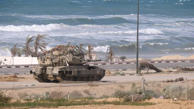 An Israeli Merkava Mark IV Barak tank moving slowly along the coastline 