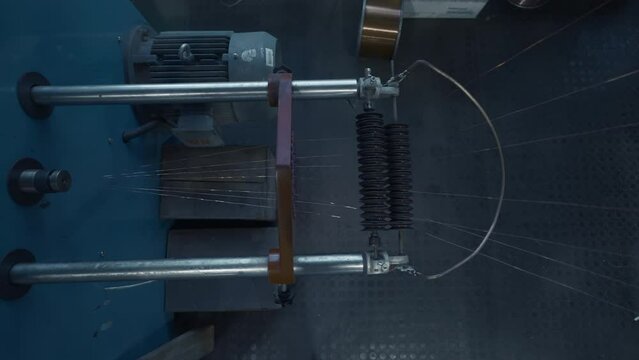 Coil winder machine with copper wire. Creative. Copper round rollers for rolling wire at the factory.