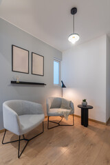 Naklejka na ściany i meble Minimalist living room with two comfortable chairs and lamp