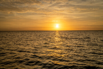 golden sunrise over Tampa Bay in Florida with some waves