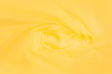 Yellow fabric background, yellow textile Abstract backgrounds, luxurious fabrics, or fluid waves or...