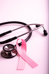Pink colored ribbon and stethoscope. Symbol of breast cancer awareness. healthcare and medicine concept. Preventive measures. Women health