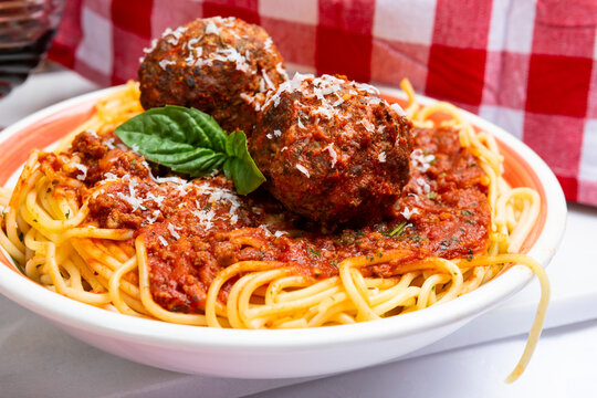 Spaghetti with meatballs in tomato sauce and parmesan cheese