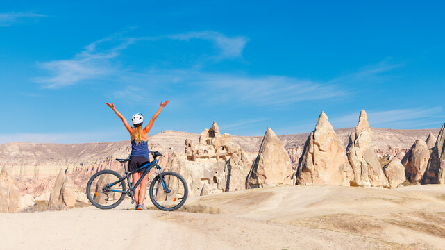 Woman with mountain bike in Turkey, Cappadocia- adventure, sport, travel concept