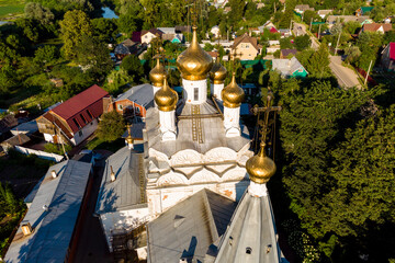 Gilded domes with crosses on an ancient Orthodox church. Spaso-Preobrazhensky Church of the 17th century. The village of Spas-Zagorie, Kaluga region, Russia