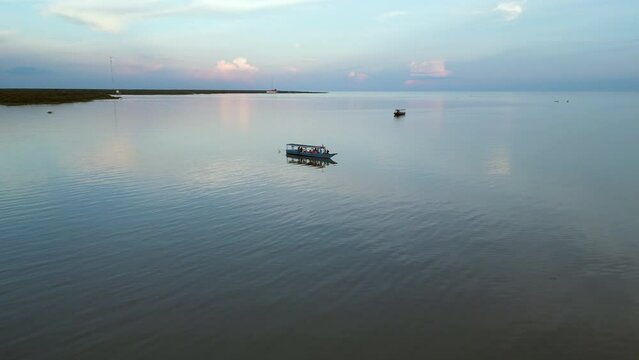 Pull Back Rise Over Listless Boats In Cambodian Lake