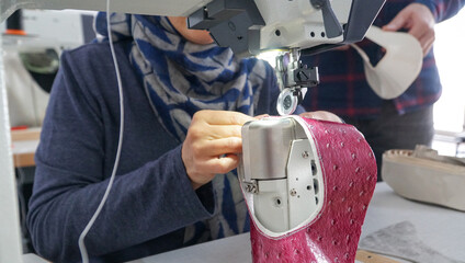 The shoemaker works meticulously