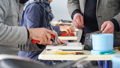 The shoemaker works meticulously