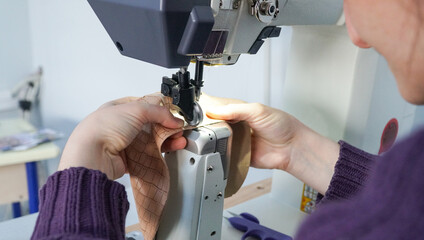 The shoemaker works meticulously