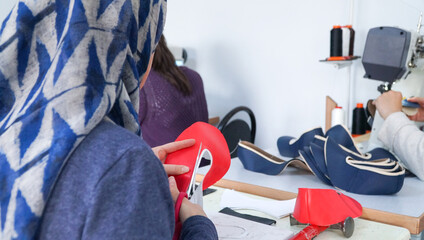 The shoemaker works meticulously