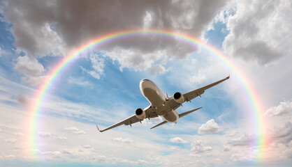 White passenger airplane under the clouds with amazing rounded rainbow - Travel by air transport