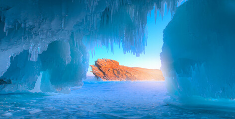 Ogoy island on winter Baikal lake with transparent cracked blue ice at sunrise   Inside the...