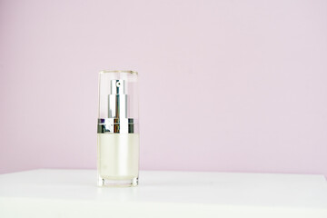 Cream container isolated on pink background cosmetic glass bottle