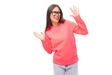 young caucasian model woman with light make-up and dark straight hair dressed in a pink sweater wears eyeglasses