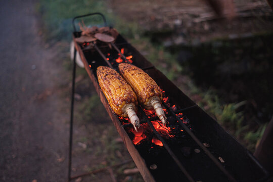 corn being burned by the roadside 

