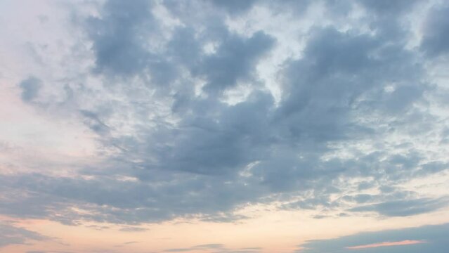 Clouds on orange sky during sunrise, time lapse