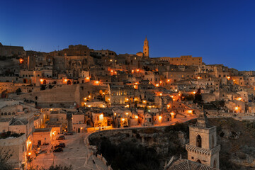 Fototapeta premium view of the old town of Matera after sunset with the lights coming on